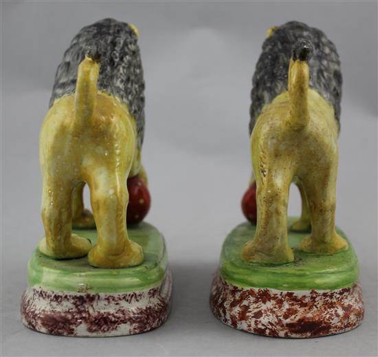 A pair of British pottery figures of lions, c.1820, 16cm., restorations